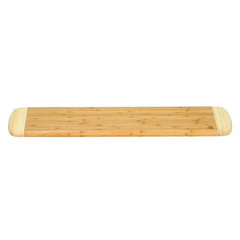 The Palaoa Bread Cutting Board by Totally Bamboo, measuring 23" x 6", features a long rectangular shape with rounded edges, elegantly placed on a crisp white background.