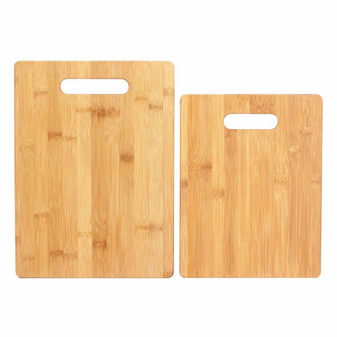 Enhance your kitchen with the Totally Bamboo 2-Piece Bamboo Cutting Board Set, featuring two rectangular boards complete with convenient cutout handles. The larger board is placed on the left and the smaller one on the right, both showcasing a natural wood grain pattern. These boards provide a knife-friendly surface ideal for all your culinary needs.