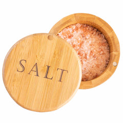 A round salt cellar from Totally Bamboo, engraved with "Salt" and featuring a swiveling lid slightly ajar, reveals its pink Himalayan salt.