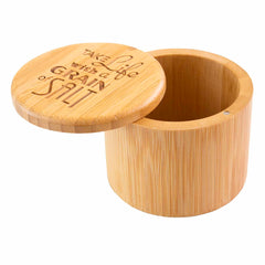 The Totally Bamboo "Grain of Salt" Engraved Salt Cellar, featuring an open lid and laser-engraved message, "Take life with a grain of salt," offers both practicality and style. This 6-ounce capacity cylindrical wooden container is a perfect addition for countertops.