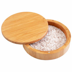 A round wooden container, evoking the Totally Bamboo "Barkeeper's Salt Box" Margarita Glass Rimmer, is filled with coarse salt. The lid is partially open, revealing the white grains inside—perfect for enhancing a margarita glass rimmer experience.