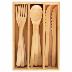 The 12-Pc. Reusable Bamboo Flatware Set with Storage Case from Totally Bamboo, made from durable Moso bamboo, is elegantly contained within a wooden organizer. This eco-friendly set includes neatly organized flatware—forks, spoons, and serrated knives—showcasing a natural wood finish against a neutral backdrop.