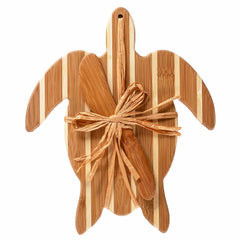 The Sea Turtle Serving Board with Spreader Knife Gift Set by Totally Bamboo features a wooden serving board adorned with a graceful striped pattern and elegantly tied with a decorative bow made from natural fibers. Ideal for presenting cheeses or other delicacies, this set is perfectly complemented by a bamboo spreader knife for an exquisite cheese service experience.