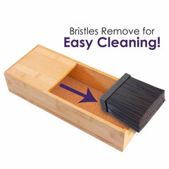 A Universal Knife Caddy by Totally Bamboo, featuring a wooden design and removable bristles for easy cleaning, is placed next to a set of kitchen knives. A purple arrow and accompanying text highlight the removable bristle feature.