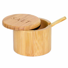 The Totally Bamboo "Salt" Engraved Little Dipper Salt Cellar, featuring a round lid secured by a magnetic lock, elegantly displays a small wooden spoon resting on its edge.