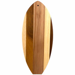 The Rock & Branch® Shiplap Series Li'l Surfer Cutting Board from Totally Bamboo is an oval wooden board with a natural finish and diverse wood tones, resembling surfboard-shaped wall art, and includes a small hole near the top edge for easy hanging.