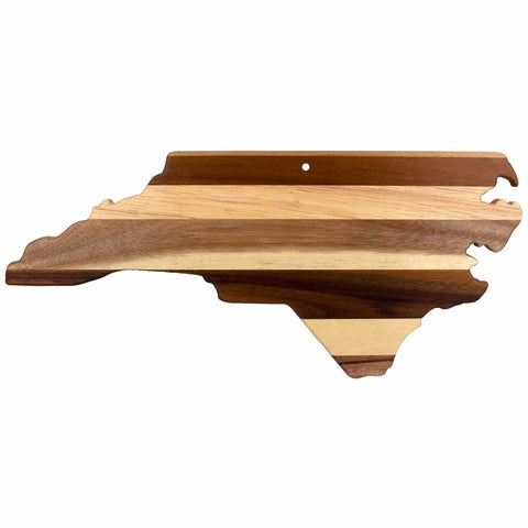 Introducing the Rock & Branch® Shiplap Series North Carolina Cutting Board by Totally Bamboo, crafted from alternating stripes of light and dark wood. This unique wooden board not only serves as a cutting surface but also doubles as elegant wall art, featuring a small hole near the top for convenient hanging.