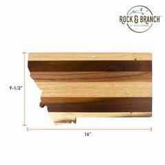 The Rock & Branch® Shiplap Series Montana Cutting Board by Totally Bamboo is crafted from wood and shaped like the state of Montana. It measures 9-1/2 inches in height and 16 inches in width, featuring alternating light and dark wood stripes that give it the look of elegant wall art. The top right corner is adorned with the Rock & Branch logo.