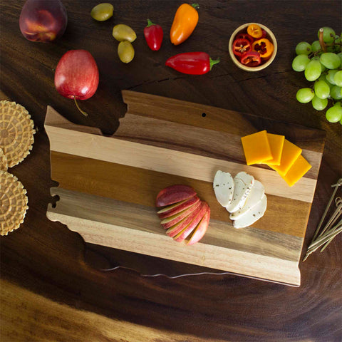 Washington state shaped serving board made of horizontal strips of mixed woods serving cheese and fruit on dark wooden table