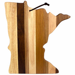 Introducing the Rock & Branch® Shiplap Series Minnesota Cutting Board by Totally Bamboo: a beautifully crafted cutting board in the shape of Minnesota, highlighted by vertical stripes of diverse wood shades and adorned with a black hanging strap at the top. This exquisite piece also serves as wall art, infusing rustic charm into any kitchen or living space.