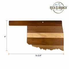 Explore the Rock & Branch® Shiplap Series Oklahoma Cutting Board by Totally Bamboo, designed in the shape of Oklahoma's state outline. This board features alternating light and dark wood stripes and measures 9 inches tall by 16-3/4 inches wide, with the "Rock & Branch by Totally Bamboo" logo prominently displayed in the top right corner.