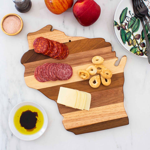 Introducing the Rock & Branch® Shiplap Series Wisconsin Cutting Board from Totally Bamboo, this exquisite piece elegantly showcases food on its wood plank design, serving as both a stunning wall decoration and a practical kitchen essential.