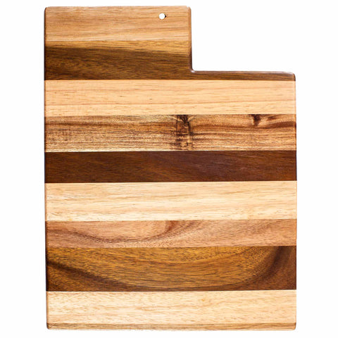 Introducing the Rock & Branch® Shiplap Series Utah Cutting Board by Totally Bamboo: a wooden cutting board crafted in the shape of Utah, featuring stylish alternating light and dark wood stripes. It includes a handy small hole at the top for effortless hanging and display.