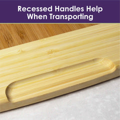 Here's a close-up of the 600SI Large Cutting Board & Noodle Board, 30" x 20", by Totally Bamboo. The image showcases its recessed handle feature, with accompanying text on a purple background reading, "Recessed Handles Help When Transporting." This board is expertly crafted to suit any kitchen task, offering both style and efficiency.