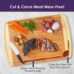 The 600SI Large Cutting Board & Noodle Board by Totally Bamboo, measuring 30" x 20", beautifully showcases sliced meat, carrots, potatoes, parsley, garlic, and a red onion. It features deep juice grooves and a collection well with an easy-pour spout for convenient use. Additionally, it comes with a knife that has a white handle for efficient slicing.