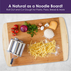 A Totally Bamboo 800SI XL Cutting Board & Noodle Board, measuring 36" x 24", adorned with fresh pasta, a pasta maker, tomatoes, red onion, parsley, garlic, cheese, an egg, and dough. Text on the image reads: "A Natural as a Noodle Board! Roll Out and Cut Dough for Pasta, Pizza, Bread & More." Perfect for any kitchen creation.