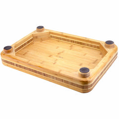 The "Big Easy" Chopping Block by Totally Bamboo is a 19" x 13-1/2" rectangular Moso bamboo cutting surface featuring raised edges and four black rubber feet at each corner to ensure stability, making it perfect for food preparation.