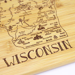 This 11" x 8-3/4" cutting board, part of Totally Bamboo's A Slice of Life Collection, boasts laser-engraved artwork featuring Wisconsin’s cities, landmarks, and local symbols, with "Wisconsin" beautifully highlighted at the bottom.