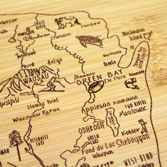 As a delightful piece from Totally Bamboo's Slice of Life Collection, the A Slice of Life Wisconsin Cutting Board (11" x 8-3/4") is beautifully crafted from bamboo and features a laser-engraved map of Wisconsin. It highlights cities such as Green Bay and Oshkosh, adorned with whimsical icons and landmarks for an enchanting touch.