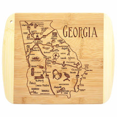 Totally Bamboo's A Slice of Life Georgia Cutting Board, measuring 11" x 8-3/4", features an intricately engraved map of Georgia with various cities and charming illustrations such as peaches and peanuts. The state outline is expertly etched, with "Georgia" prominently displayed in the upper right corner.