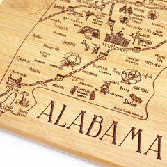 Included in the Slice of Life Collection, the A Slice of Life Alabama Cutting Board from Totally Bamboo is crafted from bamboo and beautifully engraved with a hand-drawn map of Alabama. It highlights major cities like Mobile, Montgomery, and Birmingham, while decorative icons like cotton plants and the Capitol provide added charm alongside roads and region names. The board measures 11" x 8-3/4".