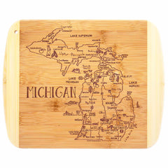 The "A Slice of Life Michigan Cutting Board" by Totally Bamboo, measuring 11" x 8-3/4", highlights a detailed map of Michigan with its Upper and Lower Peninsulas, major cities, and the Great Lakes: Lake Superior, Lake Michigan, Lake Huron, and Lake Erie. It's perfect for serving charcuterie or as a distinctive display piece featuring the state's outline.