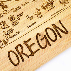 Part of the Totally Bamboo A Slice of Life Oregon Cutting Board collection, this 11" x 8-3/4" bamboo board features a detailed map of Oregon. The intricate state outline artwork highlights landmarks such as Klamath Falls and Steens Mountain, with "OREGON" prominently engraved at the bottom.