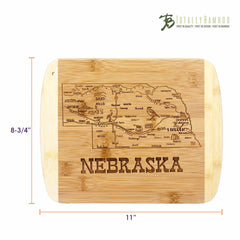 From the Totally Bamboo brand, the "A Slice of Life Nebraska Cutting Board" is part of their collection and features an engraved map of Nebraska, highlighting its cities and landmarks. This bamboo charcuterie serving board measures 11 inches in width by 8-3/4 inches in height and displays the text "Nebraska" at the bottom.