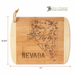 This cutting board, part of Totally Bamboo's A Slice of Life Collection, is crafted from bamboo and shaped like Nevada, featuring laser-engraved illustrations of the state's landmarks and wildlife. It includes a rope for hanging that accentuates the outline of Nevada. The dimensions are 11" by 8-3/4".