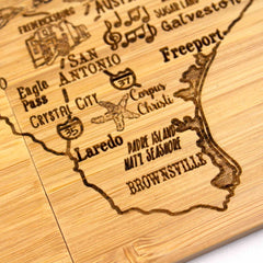 Explore the 4-Piece Texas Puzzle Coaster Set with Case from Totally Bamboo, a stunning wooden depiction of southern Texas. This laser-engraved masterpiece includes city names such as San Antonio and Laredo, accented with musical notes and an airplane icon. It’s the perfect gift for travelers and music enthusiasts alike.