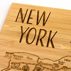 The 4-Piece New York Puzzle Coaster Set by Totally Bamboo features a striking laser-engraved design with "New York" at the top. It includes a detailed depiction of New York State, highlighting places like Niagara Falls, Buffalo, and Rochester, alongside roads and towns.