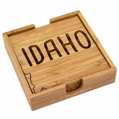 Introducing the 4-Piece Idaho Puzzle Coaster Set with Case by Totally Bamboo. This set features laser-engraved coasters adorned with "Idaho" and the state’s outline. The unique design includes a sliding lid and a small storage drawer for added practicality without compromising on charm.