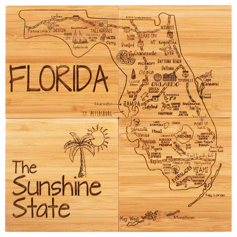 A wooden art piece from Totally Bamboo, the "4-Piece Florida Puzzle Coaster Set with Case," features a map of Florida with intricately etched details of cities and landmarks. The text "FLORIDA" and "The Sunshine State" is prominently displayed, complemented by a palm tree illustration on the left side.