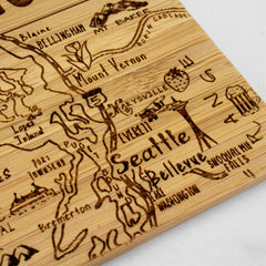 Introducing the 4-Piece Washington Puzzle Coaster Set with Case by Totally Bamboo, a beautifully hand-carved wooden depiction of the Seattle area. This set features landmarks such as the Space Needle and Mount Rainier, along with intricately etched surrounding cities and roads. With its laser-engraved design, this distinctive piece combines decorative charm with practical appeal.