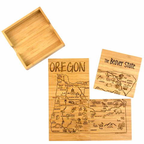 The "4-Piece Oregon Puzzle Coaster Set with Case" by Totally Bamboo outlines Oregon with laser-engraved cities and landmarks. Accompanied by an open wooden box, the pieces also feature state animals and notable locations.