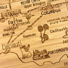 Close-up view of engraved Ohio map artwork on bamboo coaster