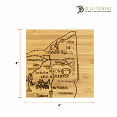 This laser-engraved artwork is a 4-piece Ohio puzzle coaster set by Totally Bamboo, showcasing a map of Ohio with cities like Cleveland, Akron, and Canton. Each bamboo coaster measures 4x4 inches and features the "Totally Bamboo" logo in the top right corner.