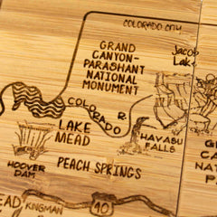 The 4-Piece Arizona Puzzle Coaster Set with Case, crafted by Totally Bamboo, features laser-engraved depictions of locations including Grand Canyon-Parashant National Monument, Lake Mead, Peach Springs, Hoover Dam, and Havasu Falls, complete with detailed geographic features and road markings.