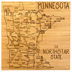 This beautifully illustrated wooden map of Minnesota, labeled "The North Star State," is showcased in the 4-Piece Minnesota Puzzle Coaster Set with Case by Totally Bamboo. It features city names like Duluth, St. Paul, and Minneapolis, as well as landmarks like Grand Portage and Voyageurs National Park—making it perfect for unique coaster gifts.