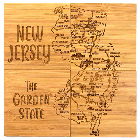 This special gift—a 4-Piece New Jersey Puzzle Coaster Set with Case from Totally Bamboo—includes coasters laser-engraved with a detailed map of New Jersey, labeled "New Jersey The Garden State." The design highlights cities like Trenton, Newark, and Atlantic City along with key landmarks and features.