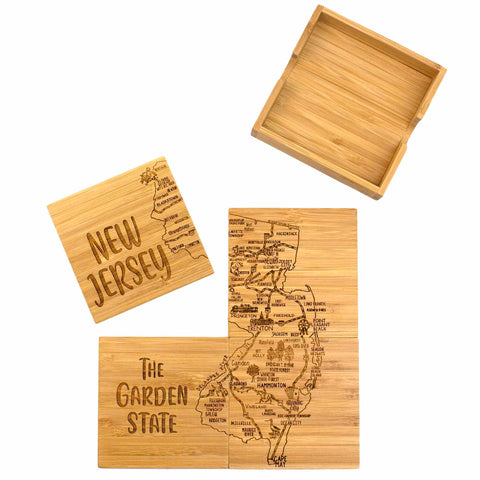 The 4-Piece New Jersey Puzzle Coaster Set with Case by Totally Bamboo features wooden coasters that form a map of New Jersey. One piece displays "New Jersey," and another highlights "The Garden State." This distinctive gift set includes a wooden storage case and intricately laser-engraved details on the coasters.