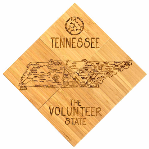 The 4-Piece Tennessee Puzzle Coaster Set with Case by Totally Bamboo is designed in the shape of the state of Tennessee and features laser-engraved details of major cities and highways. The set includes the iconic "Tennessee" text with three stars on top, while the bottom honors "The Volunteer State," making it an ideal gift for any occasion.