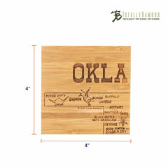 This bamboo coaster from the "Totally Bamboo" brand's 4-Piece Oklahoma Puzzle Coaster Set features a laser-engraved depiction of "OKLA" alongside a map outline that includes city names such as Boise City, Guymon, and Lawton. It measures 4 inches by 4 inches, and the brand logo is elegantly placed in the corner.