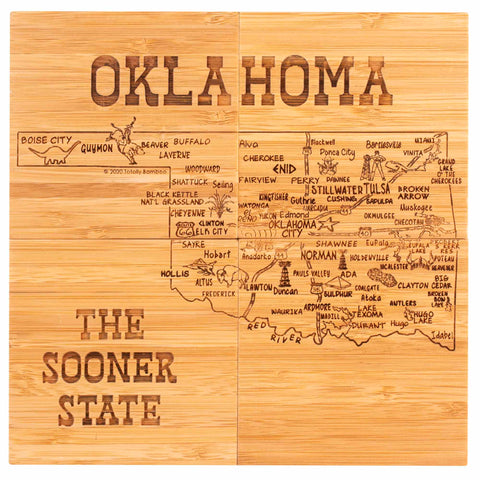 Introducing the 4-Piece Oklahoma Puzzle Coaster Set with Case from Totally Bamboo, featuring a wooden map of Oklahoma engraved with its cities and towns. This unique set serves as a distinctive coaster, with "Oklahoma" elegantly labeled at the top and "The Sooner State" at the bottom. Major cities such as Tulsa and Oklahoma City are intricately detailed, blending art with functionality for an exceptional piece.