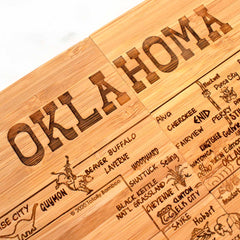 This 4-piece Oklahoma Puzzle Coaster Set by Totally Bamboo blends functionality with art, featuring laser-engraved cities, roads, and landmarks complemented by images of local wildlife and attractions. The word "OKLAHOMA" stands out at the top, providing a distinctive design for your kitchen.