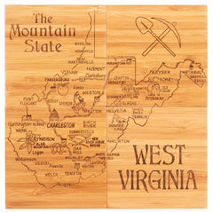 A distinctive component of the 4-piece West Virginia Puzzle Coaster Set by Totally Bamboo, this wooden board is laser-engraved with a map of West Virginia, labeled as "The Mountain State." It features towns, rivers, and iconic images such as a coal miner's pickaxe and shovel, with "West Virginia" prominently displayed in the bottom right corner.