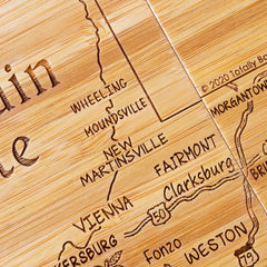 Close-up view of engraved West Virginia map artwork on bamboo coaster