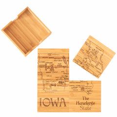 Introducing the 4-Piece Iowa Puzzle Coaster Set with Case by Totally Bamboo. This distinctive coaster set is laser-engraved with maps of Iowa, highlighting cities and notable sites. Each coaster is crafted from wood, with one placed in the included case and the others displayed to feature labels such as "Iowa" and "The Hawkeye State," creating an engaging state puzzle experience.