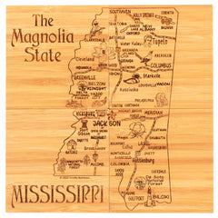 The laser-engraved wooden cutting board showcases a detailed map of Mississippi, spotlighting cities such as Jackson, Tupelo, and Biloxi. Decorated with magnolias and musical notes, it features the phrase "The Magnolia State Mississippi," making it an ideal companion piece for your unique 4-Piece Mississippi Puzzle Coaster Set with Case by Totally Bamboo.