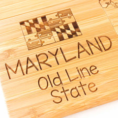 Close-up view of engraved Maryland map artwork on bamboo coaster